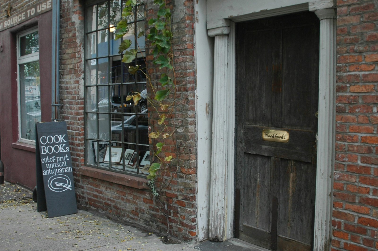a brick building with a wooden door and window